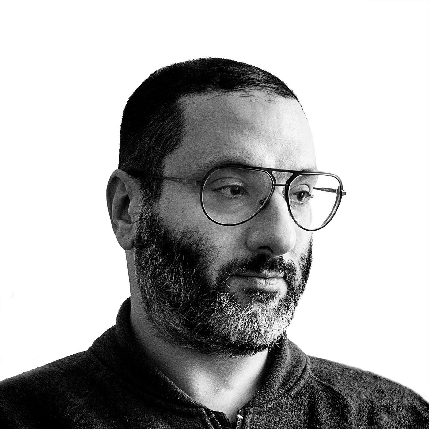 Black-and-white close portrait of Jay Muhlin wearing glasses.